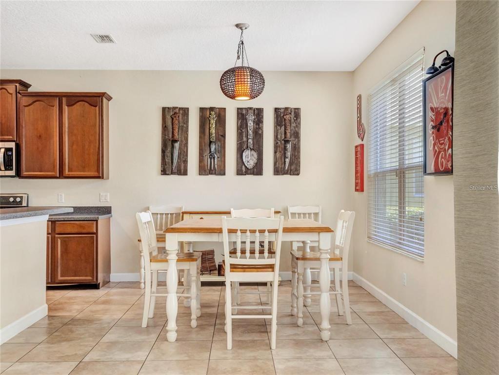 10023 Ians Ridge Road Orlando, FL 32832 - Photo 17 of 60 a view of a dining room with furniture and chandelier