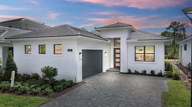 a view of a house with potted plants