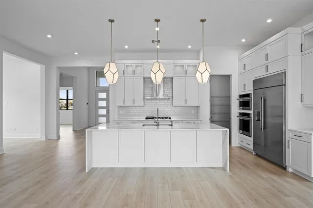 a large kitchen with stainless steel appliances kitchen island a large island in the center