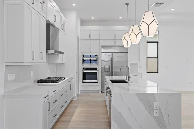 a kitchen with stainless steel appliances granite countertop a sink and cabinets