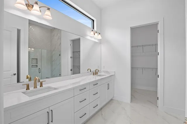 a bathroom with a double vanity sink and a mirror