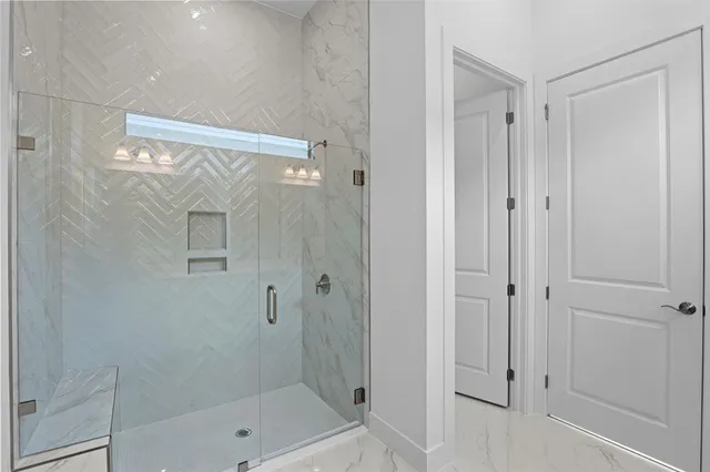 a bathroom with a glass shower door