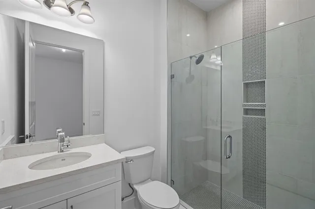 a bathroom with a sink toilet and shower
