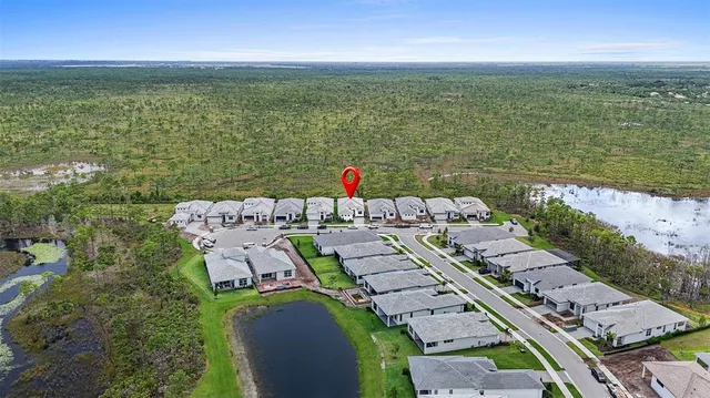 an aerial view of a house with a lake view