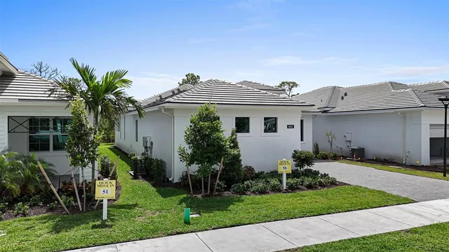 a front view of a house with a garden and plants
