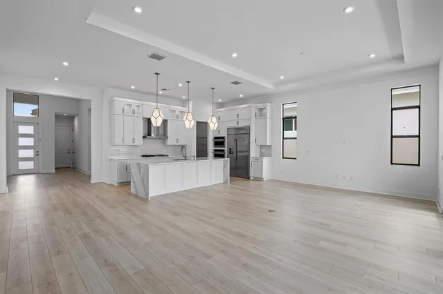 a view of kitchen with refrigerator microwave and wooden floor