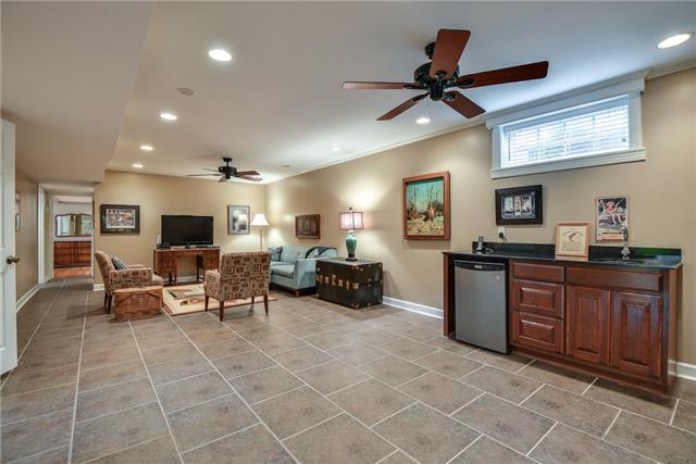 968 Sneed Road West Franklin, TN 37069 - Photo 13 of 20 Enjoy watching a game with friends in this downstairs Rec Room. It has a wet bar with granite counter tops and an under counter refrigerator. Two ceiling fans, tile flooring and recessed lighting make this room comfortable and modern.