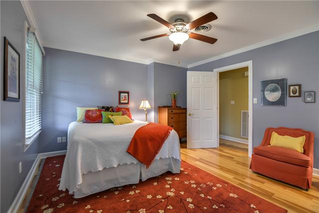 968 Sneed Road West Franklin, TN 37069 - Photo 10 of 20 Bedroom #2 has a ceiling fan, hickory hardwood floors, crown molding, and two closets.