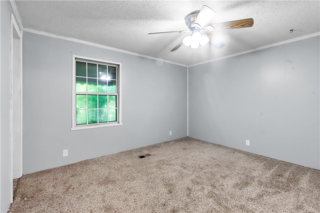 178 Childress Road Pickens, SC 29671 - Photo 16 of 32 A well-lit room offers comfort with carpeted flooring and a convenient ceiling fan.
