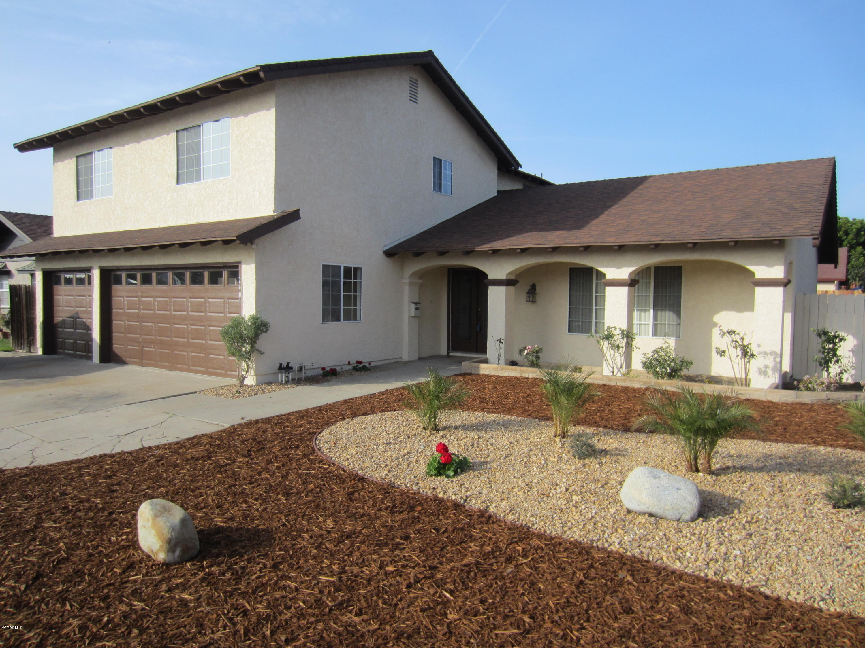a front view of a house with backyard