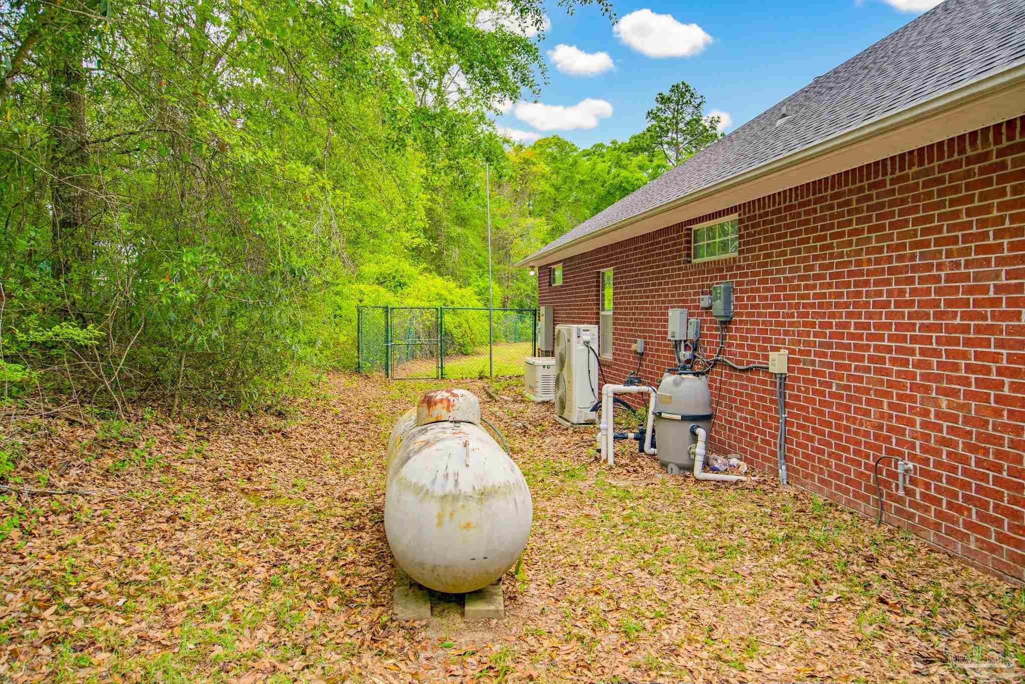 2855 Walling Road Milton, FL 32570 - Photo 55 of 55 a backyard of a house with table and chairs