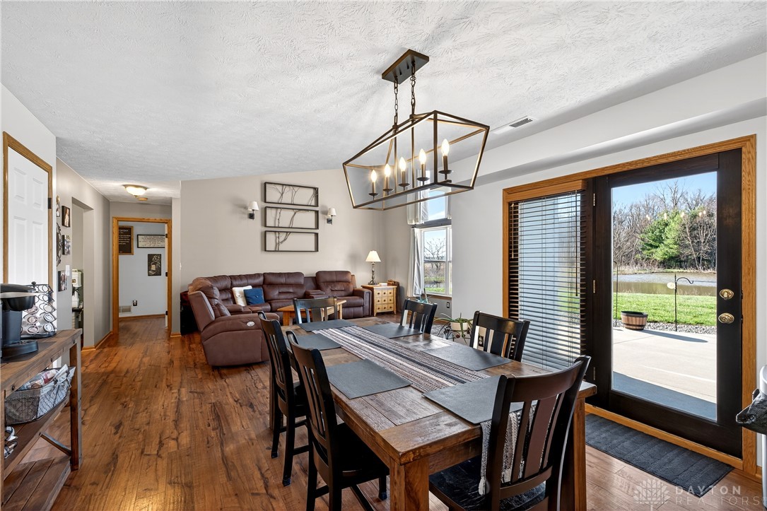 6560 Snyder Road Fletcher, OH 45326 - Photo 18 of 71 This inviting space features an open layout with rich wood flooring, perfect for gatherings.