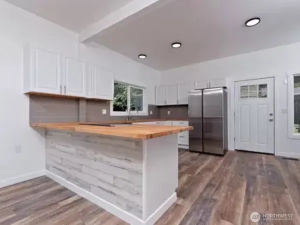 a kitchen with stainless steel appliances a refrigerator sink and cabinets