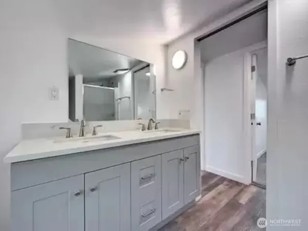 a bathroom with a double vanity sink and mirror