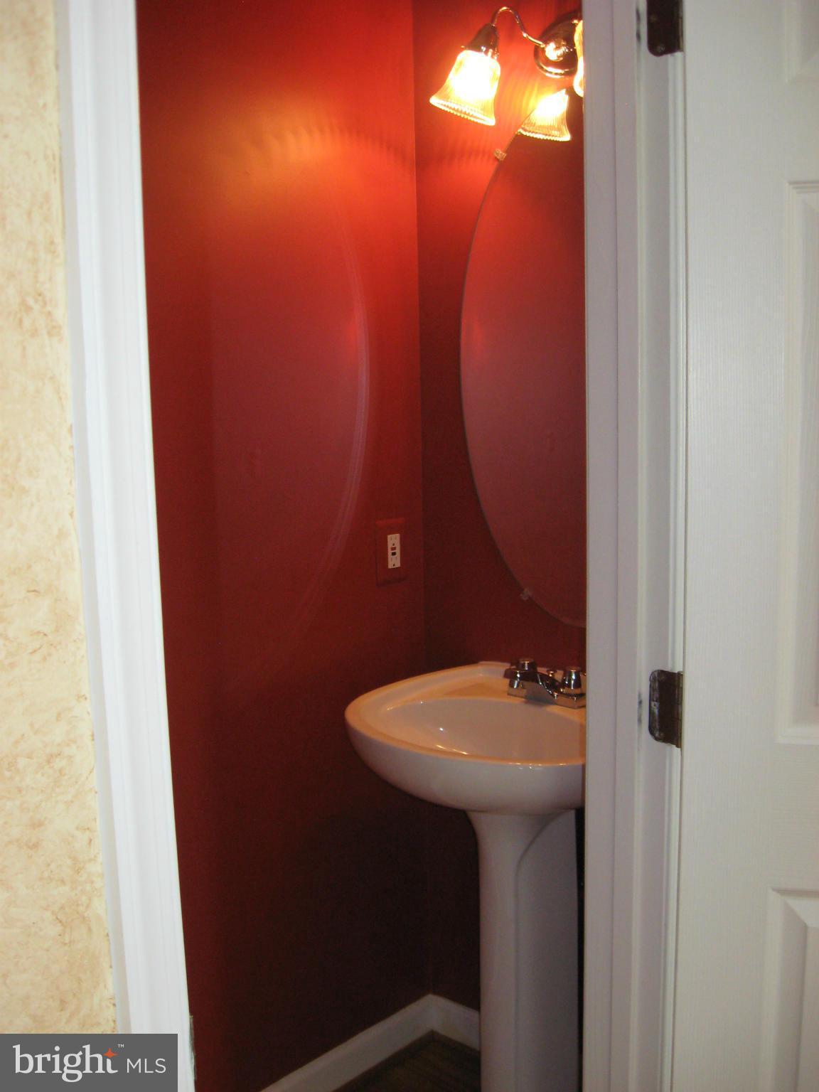 8822 Mapleville Road Mount Airy, MD 21771 - Photo 7 of 27 a bathroom with a sink and mirror
