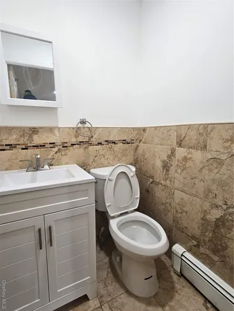 a bathroom with a toilet a sink and mirror