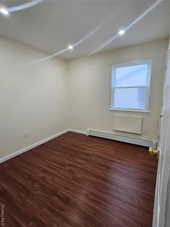 a view of room with wooden floor and cabinet