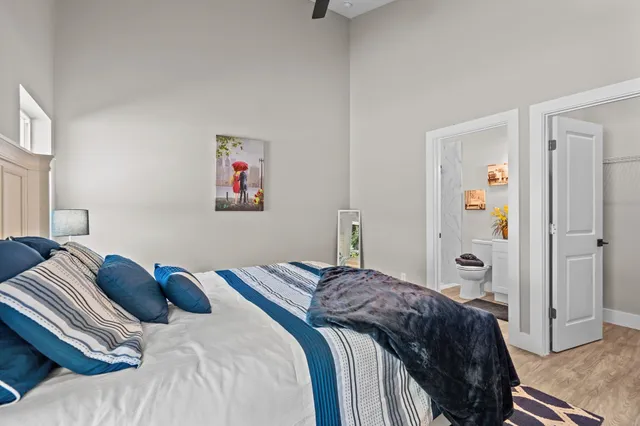 a bedroom with a bed and a painting on the wall