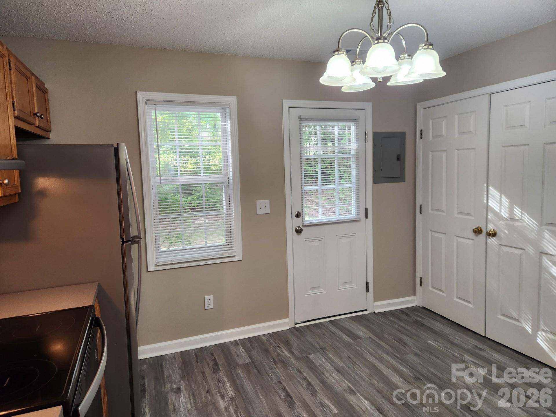 159 Pounds Avenue Southwest Concord, NC 28025 - Photo 4 of 10 a view of an empty room with wooden floor and a window