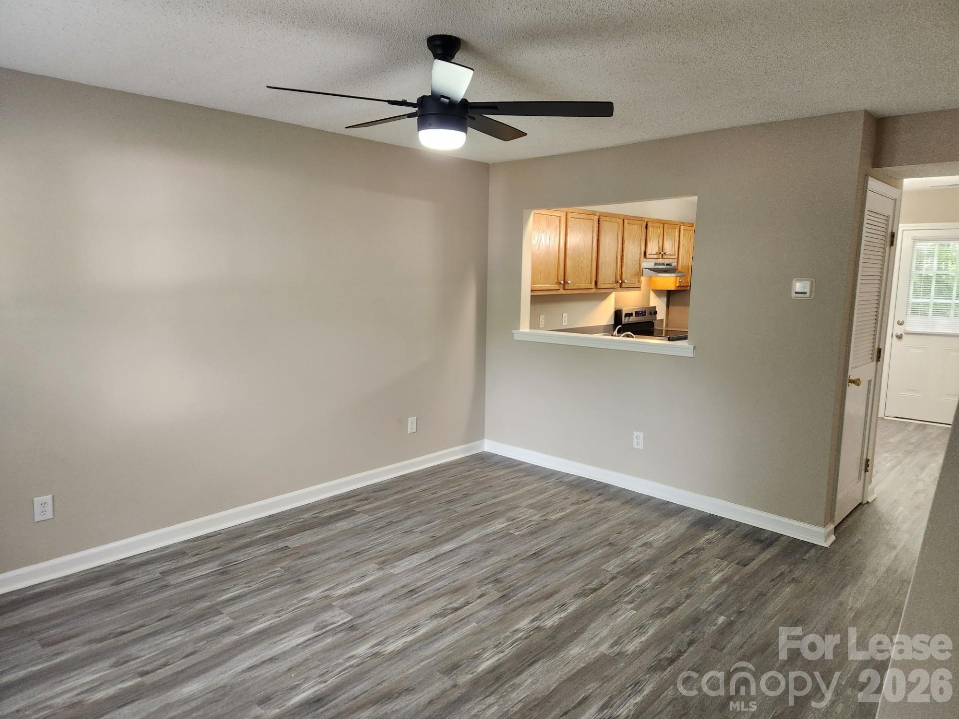 159 Pounds Avenue Southwest Concord, NC 28025 - Photo 5 of 10 wooden floor in an empty room with a window