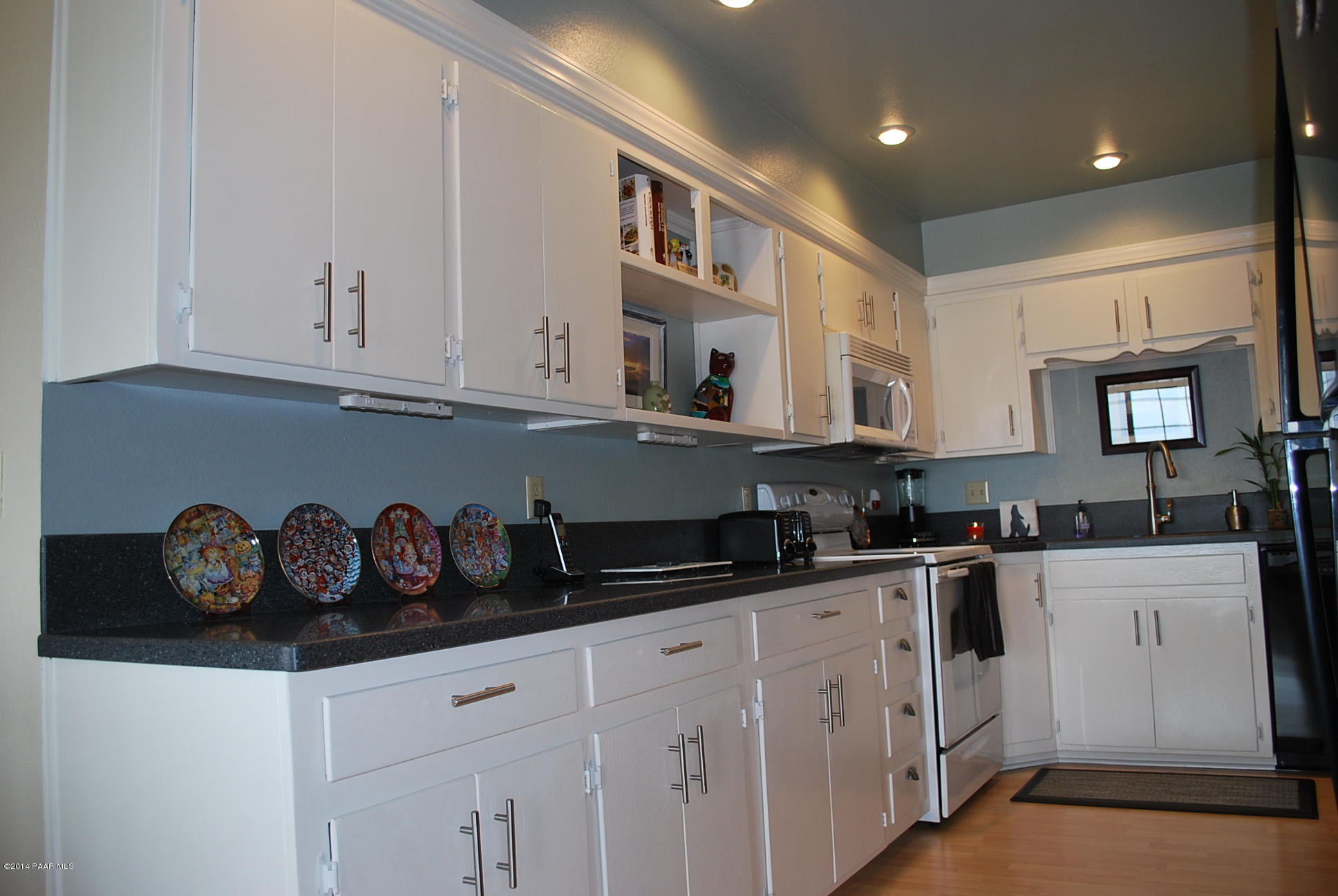 2701 Ridge Road Prescott, AZ 86301 - Photo 21 of 39 a kitchen with granite countertop white cabinets and white appliances