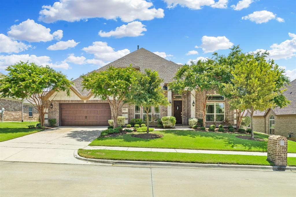 1102 Ballycastle Lane Corinth, TX 76210 - Photo 1 of 1 a front view of a house with a yard table and chairs