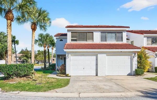a house with palm tree in front of it