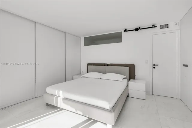 a large white bed in a white room