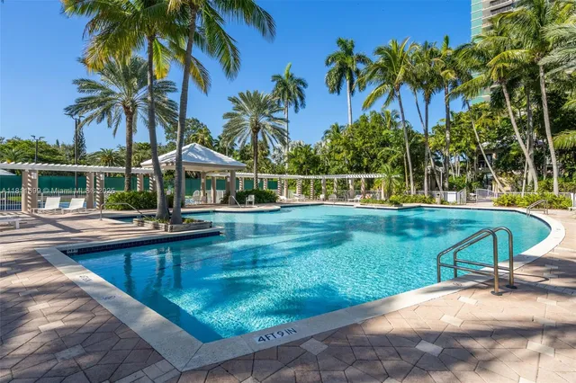 a swimming pool with outdoor seating yard and barbeque oven