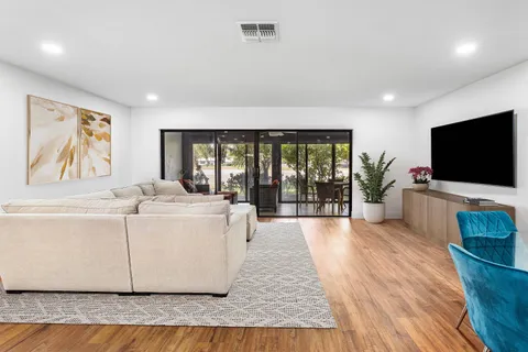 a living room with a large window and a flat screen tv