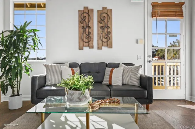 a living room with furniture flowerpot and wooden floor
