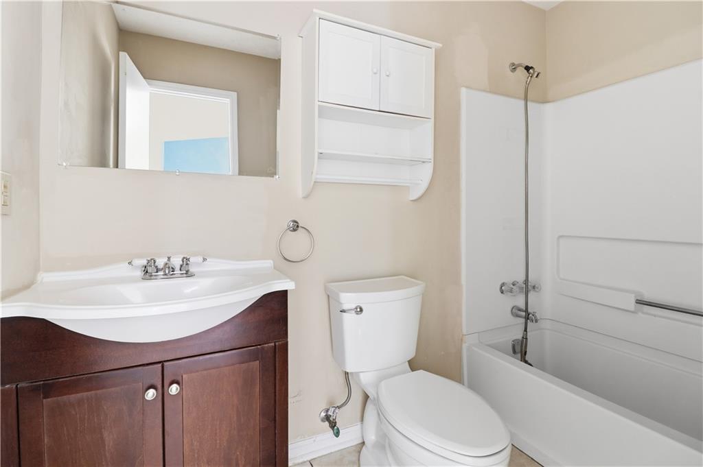 5288 Biffle Downs Road Stone Mountain, GA 30088 - Photo 13 of 18 a bathroom with a sink a toilet and shower