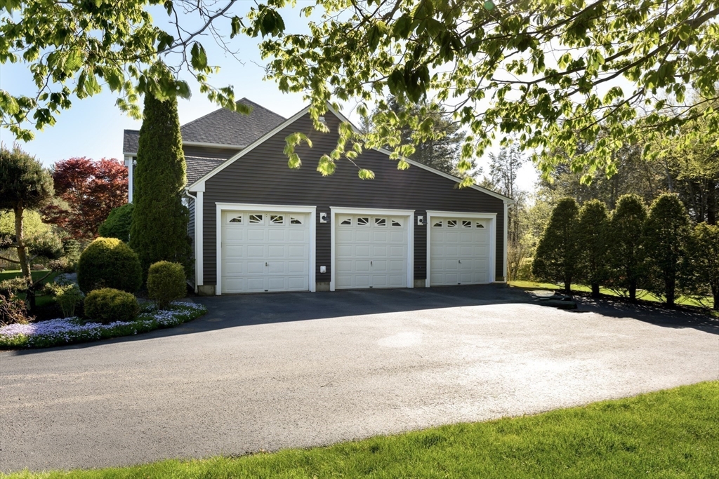 27 Vista Circle Rutland, MA 01543 - Photo 27 of 35 a front view of a house with a yard and garage