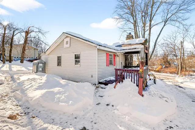 a view of a house with a yard covered in snow