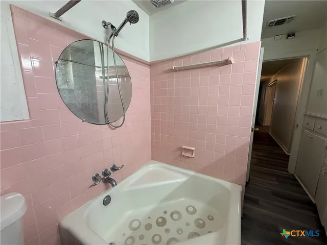 a bathroom with a sink and mirror