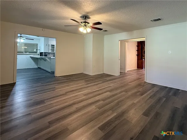 a view of a kitchen with wooden floor and a kitchen