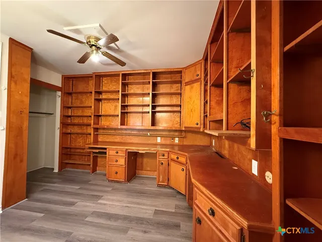 a view of a kitchen cabinets and a wooden floor
