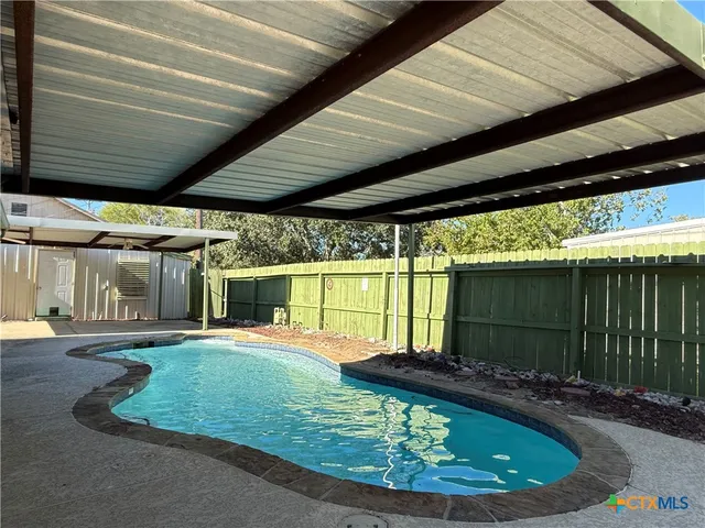 a view of a swimming pool with a patio