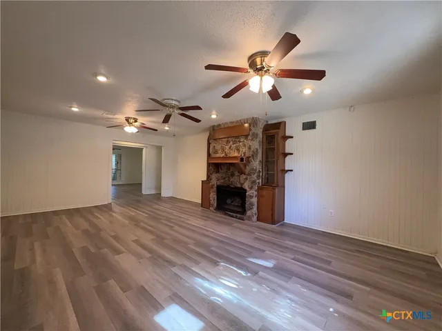 a view of a livingroom with a fireplace and chandelier