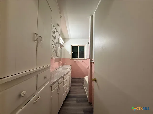 a bathroom with a double vanity sink and a mirror