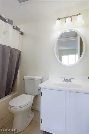 a bathroom with a sink toilet and mirror