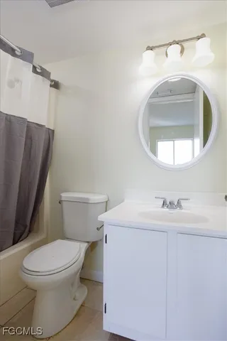 a bathroom with a sink toilet and mirror