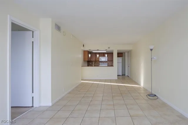 a view of a big room with windows and entryway