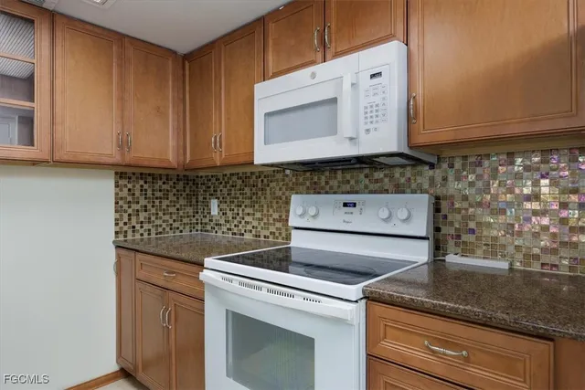 a stove top oven sitting inside of a kitchen