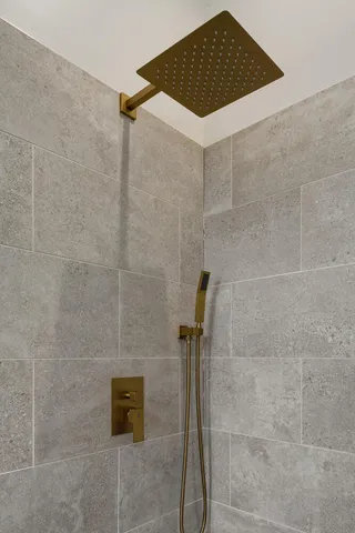 a bathroom with a shower and a sink