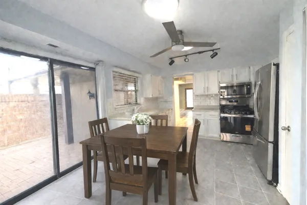 a large kitchen with cabinets and stainless steel appliances