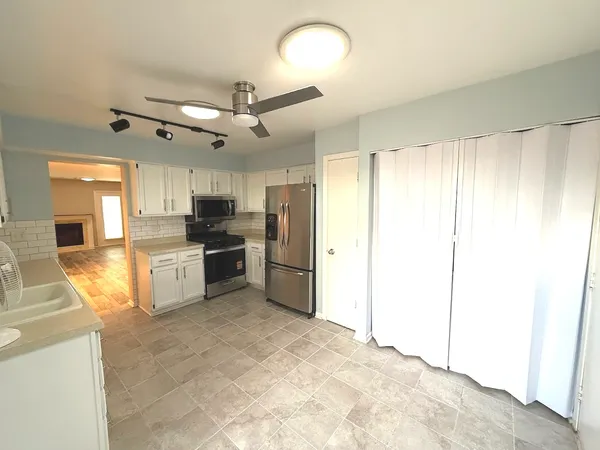 a view of a room with wooden floor