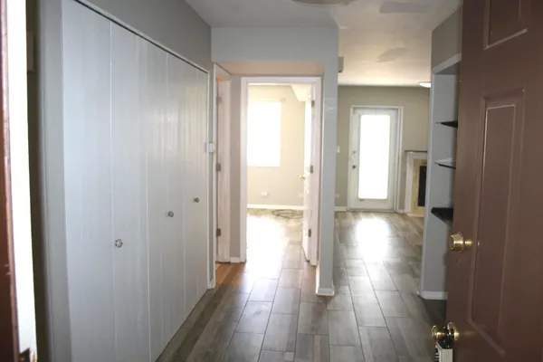 a view of hallway with wooden floor
