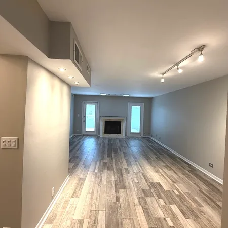 a dining room with stainless steel appliances a table and chairs