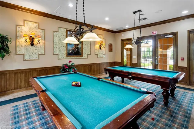 a room with pool tables and windows